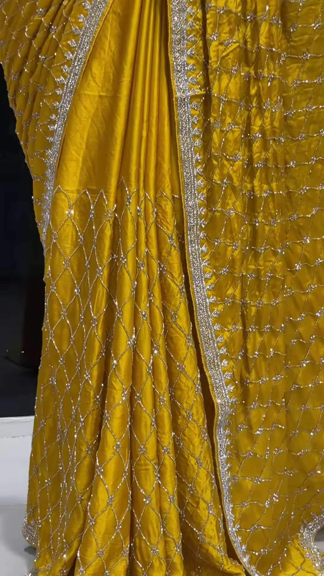 Radiant Yellow Georgette Saree with All-Over Sequin Lattice Pattern and Ornate Silver Zari Border